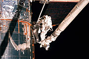 Astronauts Lee and Smith repairing Hubble Astronauts Lee and Smith repairing parts of Hubble's insulation.